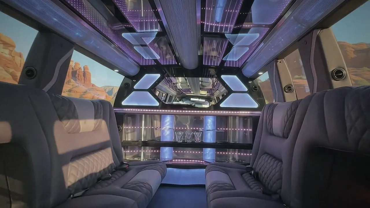 Inside the Cadillac Escalade limo in Boulder: LED light-show ceiling, leather lounge seating and lit bar